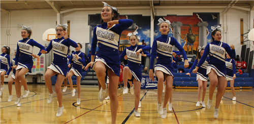 Cheerleaders performing at basketball game halftime 